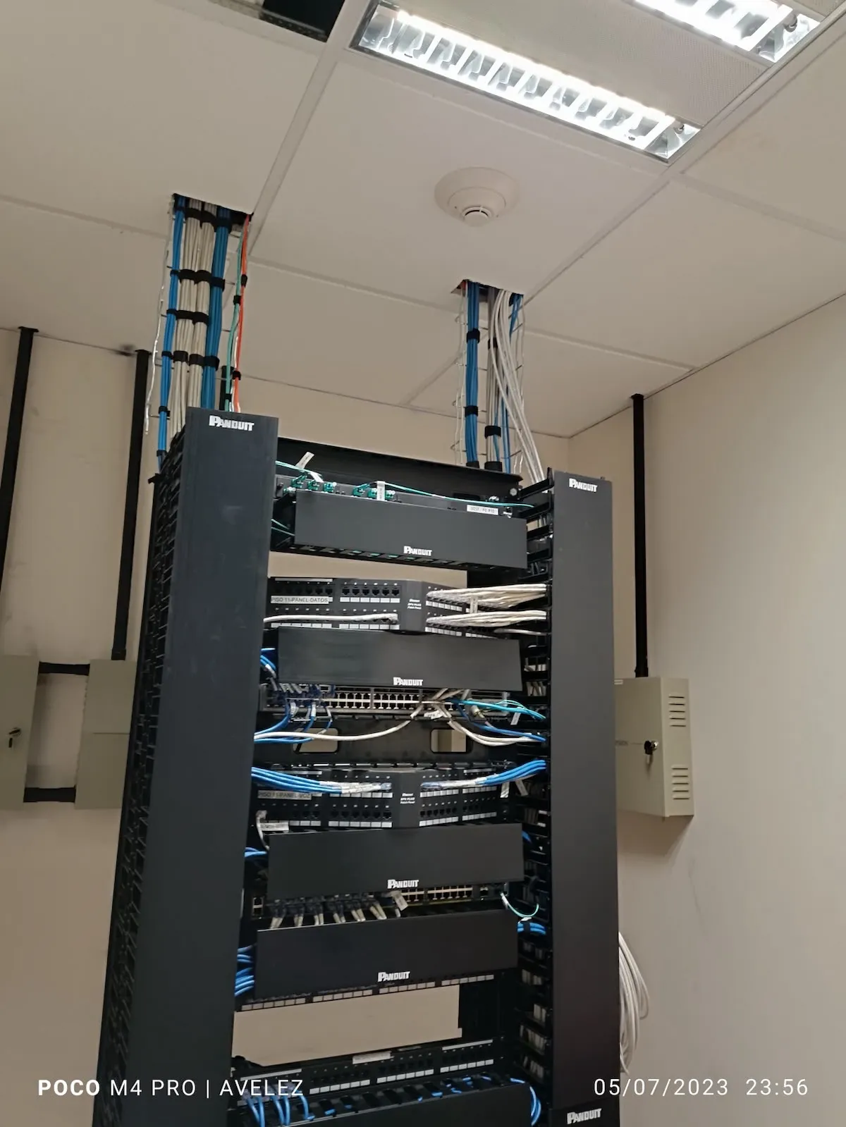 Rack Panduit de telecomunicaciones con peinado de cableado UTP azul y blanco hacia plafón