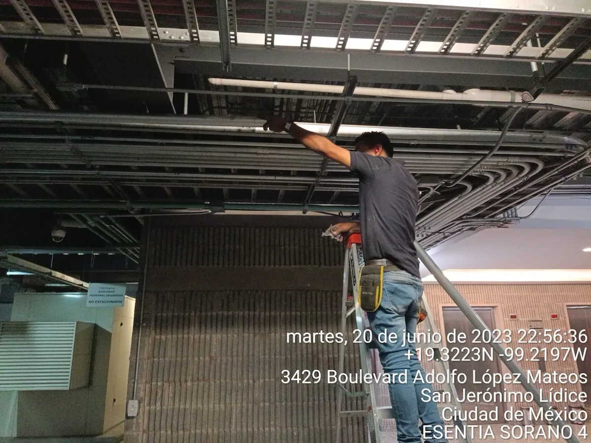 Técnico instalando escalerilla portacables en losa de Sótano 4